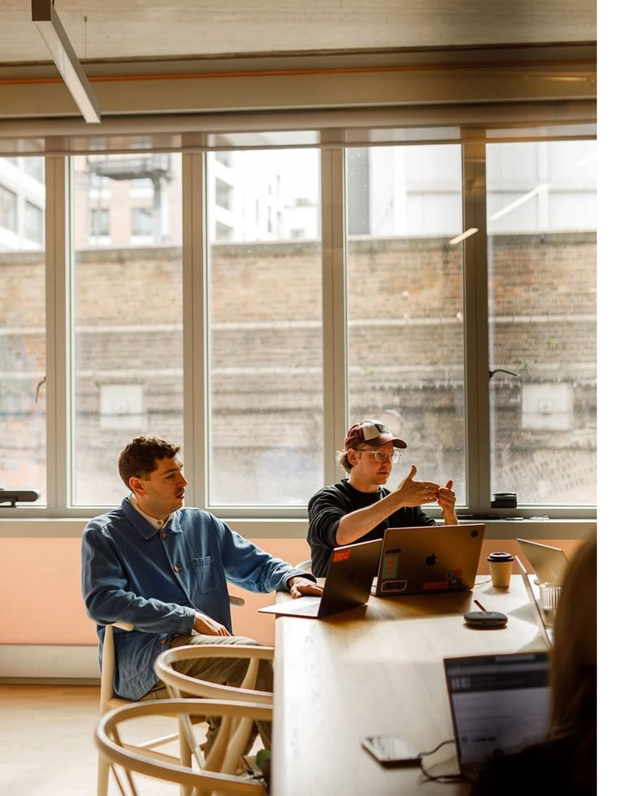 Untreated portrait photograph of two colleagues collaborating at a table